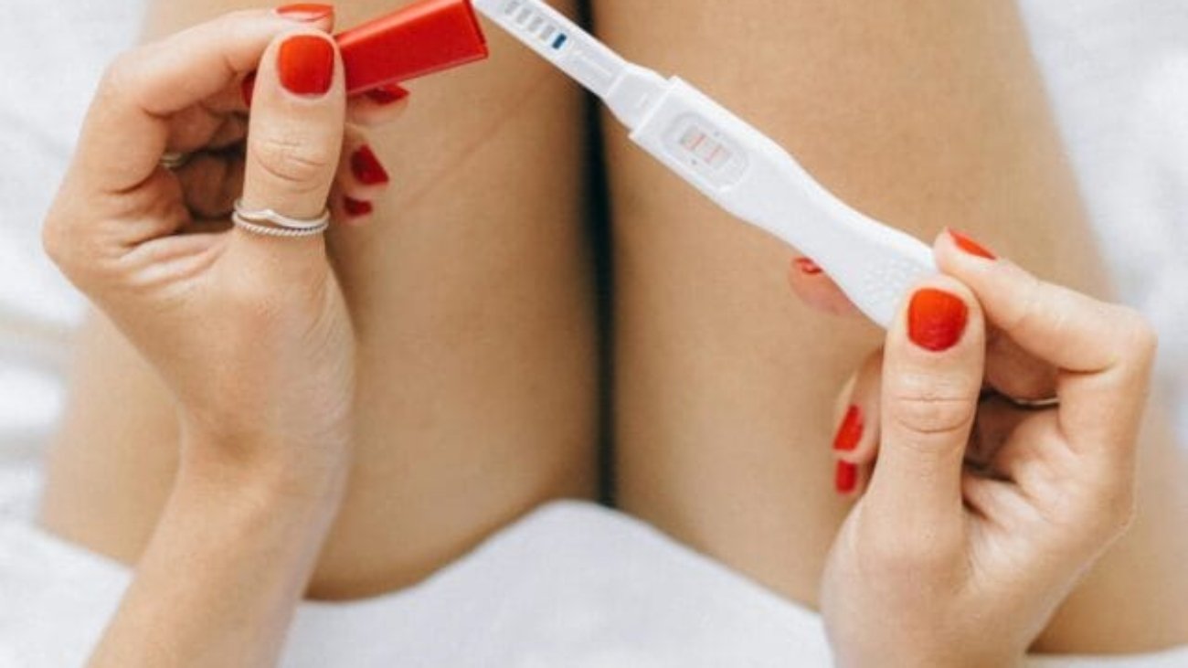 Girl-Holding-Pregnancy-Test-Result