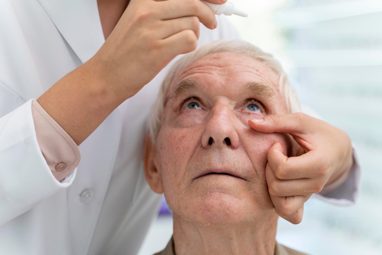 doctor pouring some eye drops patient scaled